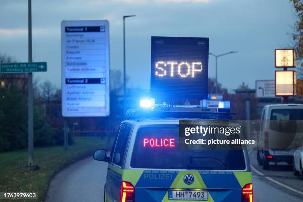 November 2023, Hamburg: Emergency services close off the access road to Hamburg Airport during an operation. An armed man is holding his...
