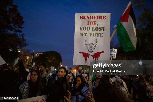 Demonstrator holding a sign with Genocide Joe, You Lost My Vote written on it, gathers in front of the White House during the National March on...