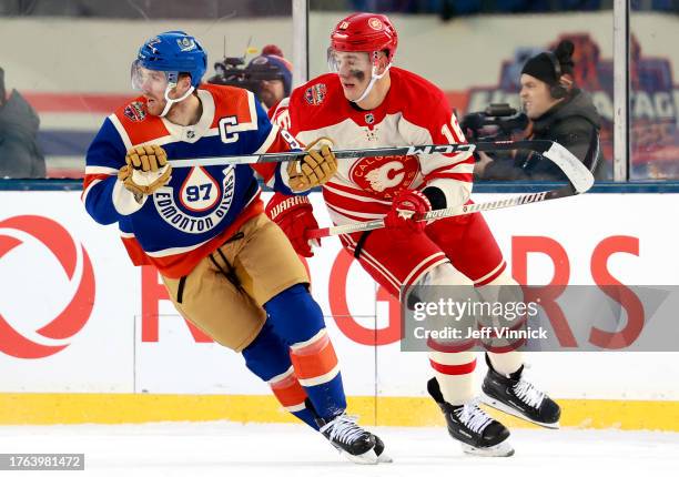 Connor McDavid of the Edmonton Oilers and Nikita Zadorov of the Calgary Flames pursue the play during the first period of the 2023 Tim Hortons NHL...