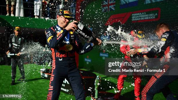 Race winner Max Verstappen of the Netherlands and Oracle Red Bull Racing, Second placed Lewis Hamilton of Great Britain and Mercedes and Third placed...