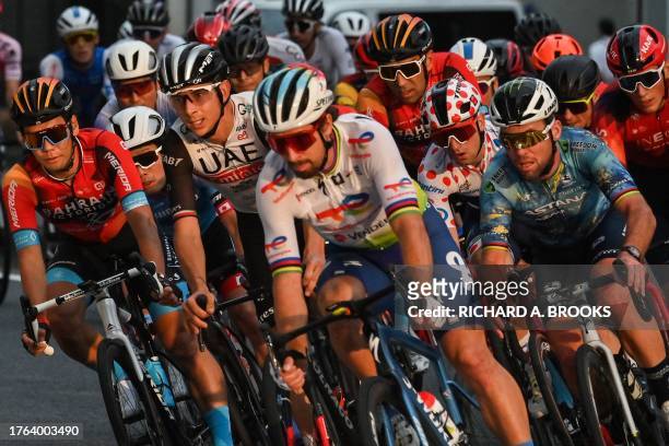 Tour de France Criterium Legends team members Mark Cavendish of Britain and Peter Sagan of Slovakia join top riders as they take a turn during the...