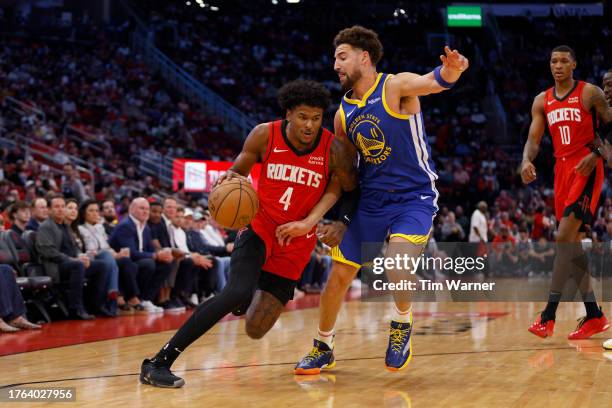 Klay Thompson of the Golden State Warriors defends Jalen Green of the Houston Rockets in the first half at Toyota Center on October 29, 2023 in...