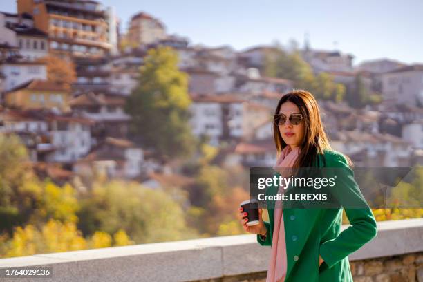 autumn portrait of a young woman in an urban environment - lerexis stock pictures, royalty-free photos & images