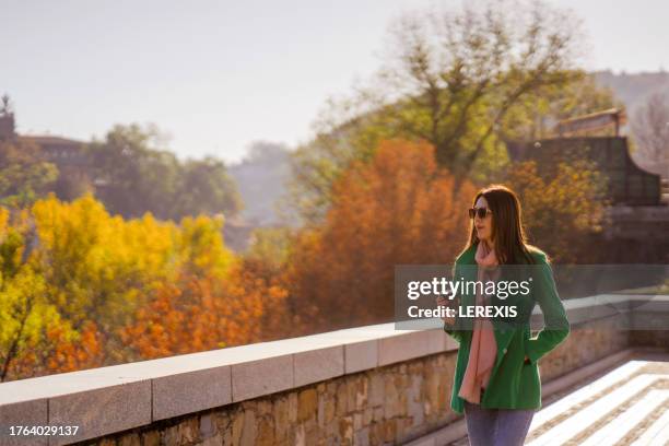 beautiful woman walking in the city park - lerexis stock pictures, royalty-free photos & images