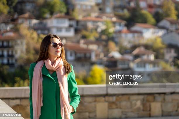 autumn portrait of a young woman in an urban environment - lerexis stockfoto's en -beelden