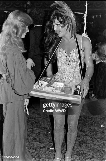 Costumed cigarette vendor attends a party, celebrating America's bicentennial , at the Palladium in Hollywood, California, on June 16, 1975.