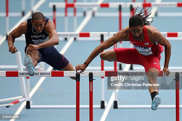 Thomas Martinot-Lagarde of France and Jason Richardson of the United States compete in the Men's 110 metres hurdles semi final during Day Three of...