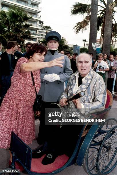 French director Agnes Varda gives instructions to actors in Cannes on May 13, 1994 during the shooting of her next movie "Mes cent et une nuits"...