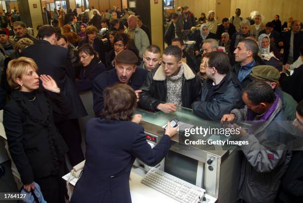 Stranded passengers crowd the Air counter February 6, 2003 at Orly airport in France. Air Lib, France's second largest carrier, grounded its fleet...