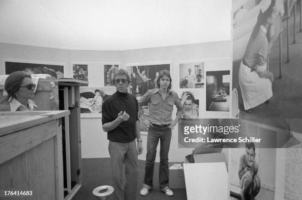 British photographer Antony Armstrong-Jones, 1st Earl of Snowdon speaks with Beverly Chamberlain and another as he sets up an exhibition of his work,...