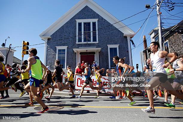 Elite runners take off from the starting line of the 41st Falmouth Road Race in Woods Hole, Mass., Aug. 11, 2013.