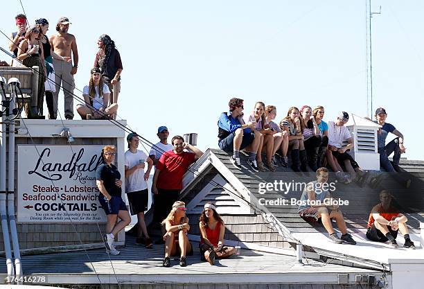 Spectators watch as runners take off from the starting line of the 41st Falmouth Road Race in Woods Hole, Mass., Aug. 11, 2013.