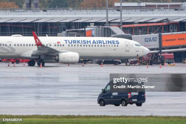 Police van observes the car of the hostage taker, parked under a Turkish airline aircraft at Hamburg Airport on November 5, 2023 in Hamburg, Germany....