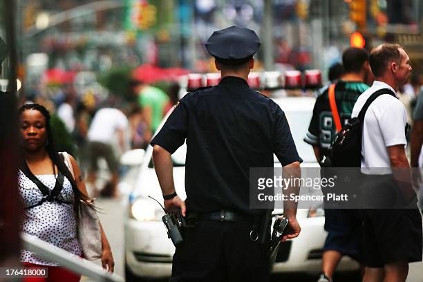 New York City police officer stands in Times Square on August 12, 2013 in New York City. The controversial policy employed by the New York Police...