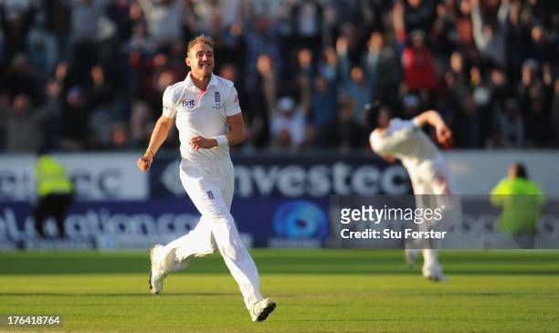 England fielder James Anderson throws the ball up in celebration after taking the winning catch to dismiss Peter Siddle as bowler Stuart Broad...