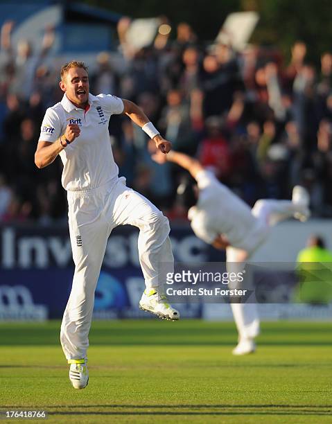 England fielder James Anderson throws the ball up in celebration after taking the winning catch to dismiss Peter Siddle as bowler Stuart Broad...