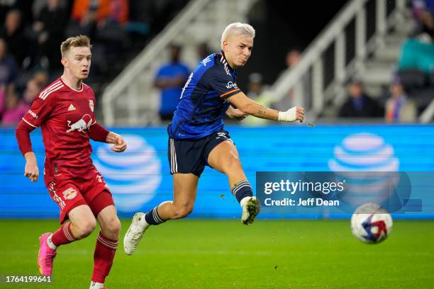 Álvaro Barreal of FC Cincinnati scores as Cameron Harper of New York Red Bulls looks on during the second half of a MLS playoff match at TQL Stadium...