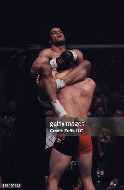 Carlos Newton attempts to submit Matt Hughes with a triangle choke submission during their welterweight championship bout at UFC 34 inside the MGM...