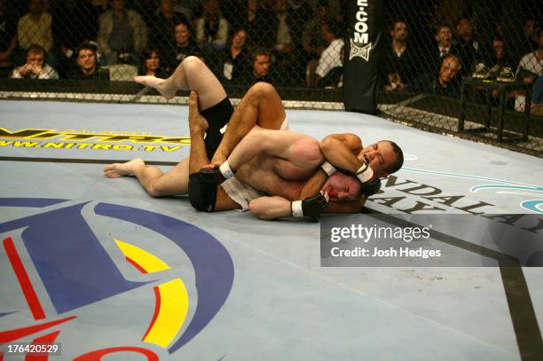 Penn secures a rear choke submission against Matt Hughes during their welterweight championship bout at UFC 46 inside the Mandalay Bay Events Center...