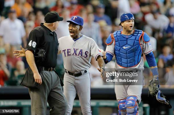 Texas Rangers manager Ron Washington gets between A.J. Pierzynski of the Texas Rangers and home plate umpire Ron Kulpa after Pierzynaski was ejected...