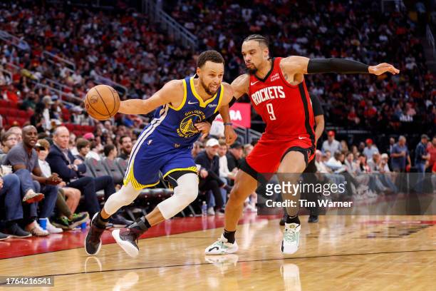 Stephen Curry of the Golden State Warriors drives to the basket while defended by Dillon Brooks of the Houston Rockets in the second half at Toyota...