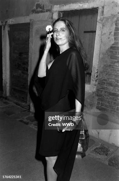 Marie Brandolini AKA Countess Marie Brandolini d'Adda di Valmareno holds flower given by attendants during dinner party after "Made in Milan" film...