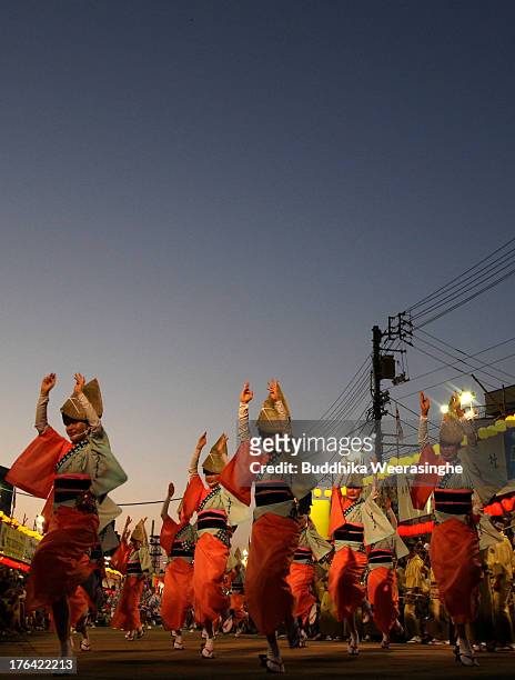 Japanese women dressed in traditional costume perform Awa-Odori dance during the annual 'Awa odori' or Awa Dance Festival on August 12, 2013 in...