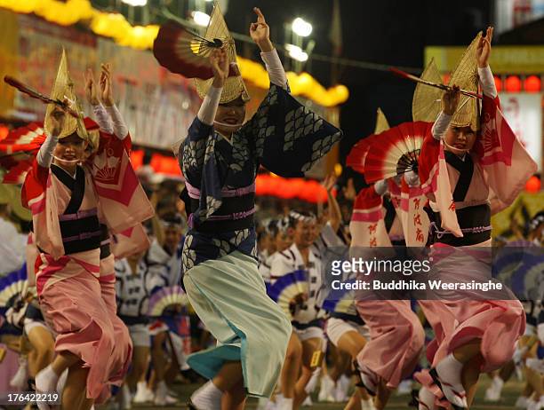 Japanese women dressed in traditional costume perform Awa-Odori dance during the annual 'Awa odori' or Awa Dance Festival on August 12, 2013 in...