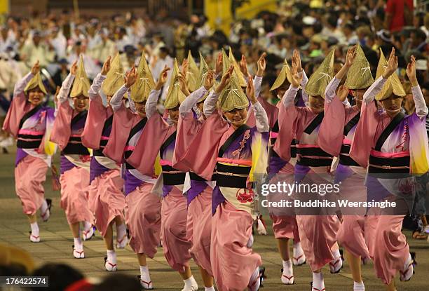 Japanese women dressed in traditional costume perform Awa-Odori dance during the annual 'Awa odori' or Awa Dance Festival on August 12, 2013 in...