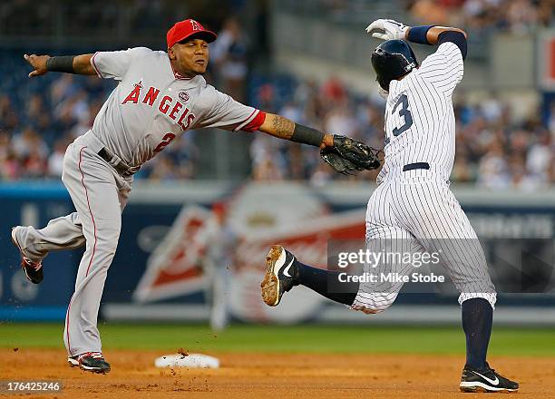 Alex Rodriguez of the New York Yankees is tagged out trying to steal second base by Erick Aybar of the Los Angeles Angels of Anaheim in the second...