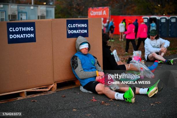 Runners rest before the start of the 52nd Edition of the New York City Marathon on November 5, 2023.