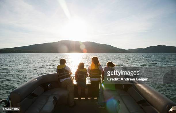 children riding in front of pontoon boat at sunset - lake whitefish stock pictures, royalty-free photos & images