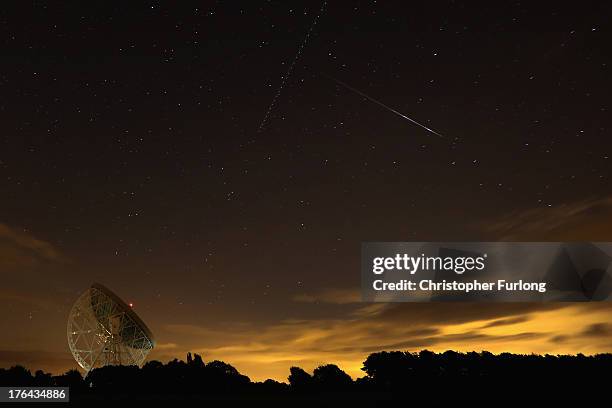 Perseid meteor streaks across the sky over the Lovell Radio Telescope at Jodrell Bank on August 13, 2013 in Holmes Chapel, United Kingdom.The annual...