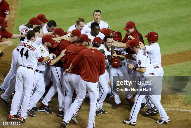 Adam Eaton of the Arizona Diamondbacks and teammates celebrate a game-winning walk-off home run against the Baltimore Orioles at Chase Field on...