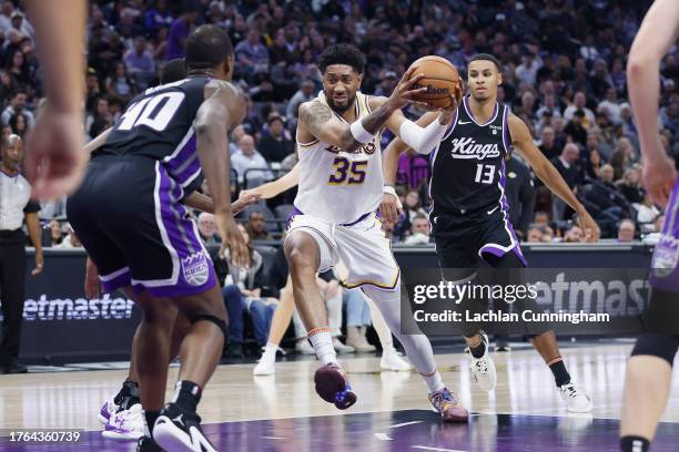 Christian Wood of the Los Angeles Lakers drives to the basket against Harrison Barnes of the Sacramento Kings in the second quarter at Golden 1...