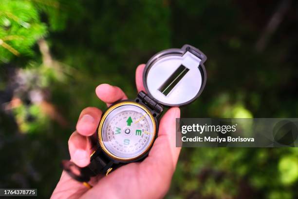 compass in hand close up. - amber alert stock pictures, royalty-free photos & images