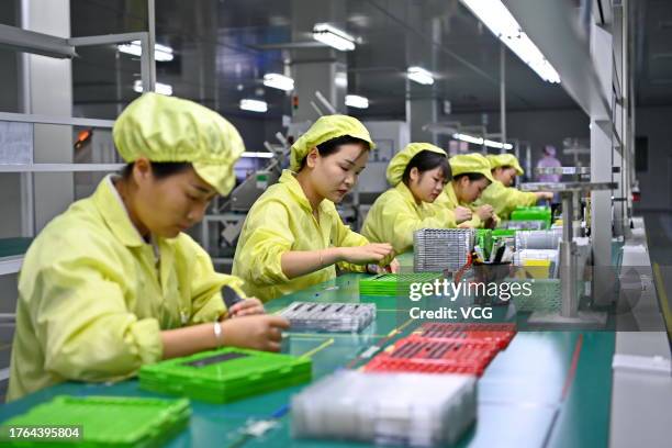 Employees work on the production line of chip card products at a digital workshop of Shenzhen Einolda Smart-Card Mfg Co., Ltd. On October 28, 2023 in...