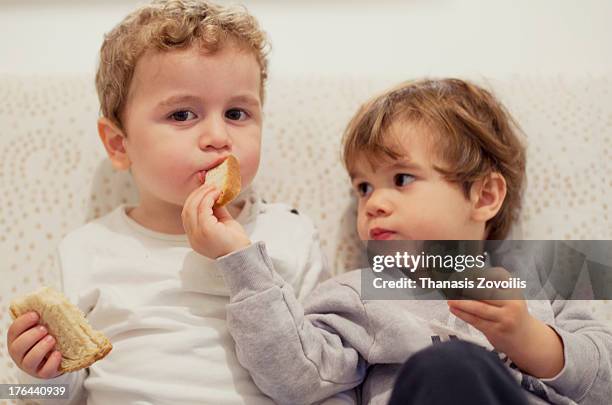 portrait of two small boys - sharing foto e immagini stock