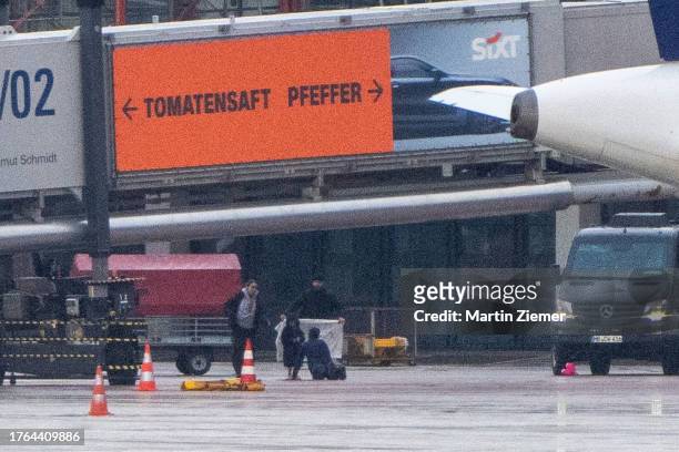 The hostage taker surrenders and lies on the ground talking to his daughter, on the tarmac at Hamburg Airport on November 5, 2023 in Hamburg,...