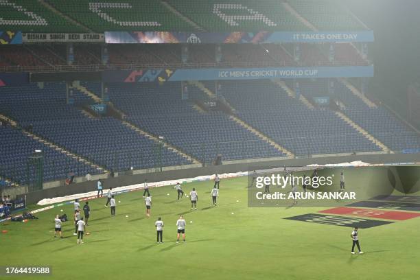 Sri Lanka's players attend a practice session amid smoggy conditions on the eve of their 2023 ICC Men's Cricket World Cup one-day international match...