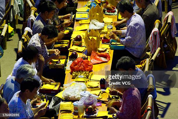 People attend prayers to greet the Chinese Valentine's Day at Dizang Temple on August 12, 2013 in Hangzhou, China. The Chinese Valentine's Day falls...
