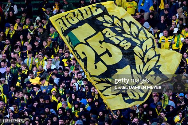 Nantes' supporters wave a giant flag ahead of the French L1 football match between FC Nantes and Stade de Reims at the Stade de la BeaujoireLouis...