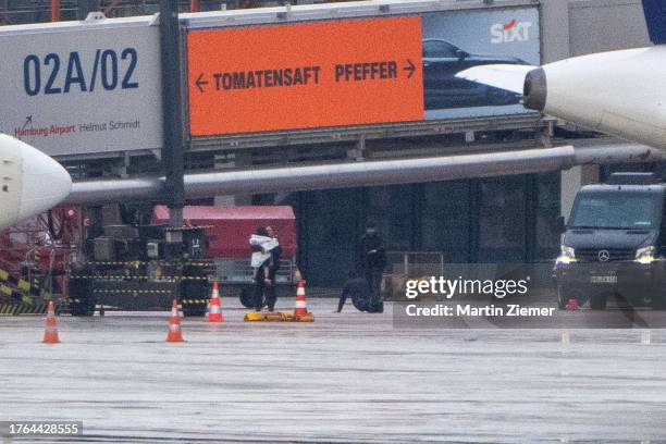 Woman wrapping the hostage in a blanket, while the hostage taker is surrendering on the tarmac at Hamburg Airport on November 5, 2023 in Hamburg,...