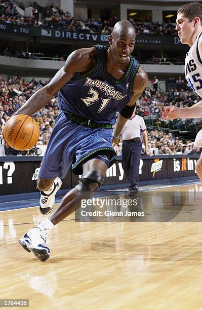 Kevin Garnett of the Minnesota Timberwolves drives against Raef LaFrentz of the Dallas Mavericks during the game at American Airlines Center on...