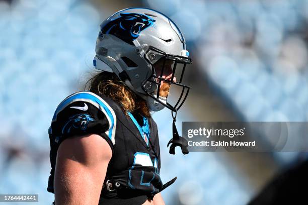 Hayden Hurst of the Carolina Panthers stands on the field during warm ups before their game against the Houston Texans at Bank of America Stadium on...