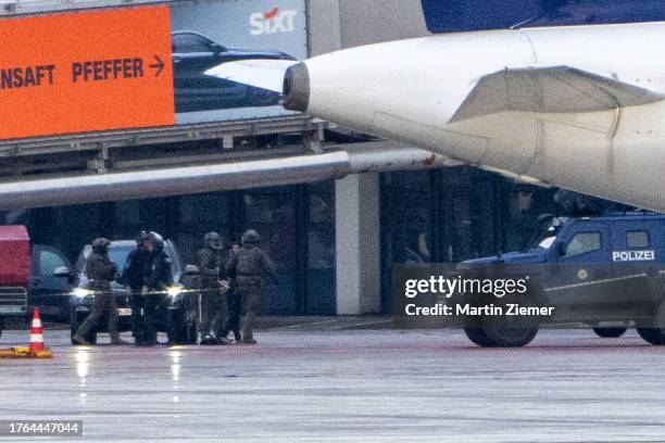 Police officers arrest the hostage taker on the tarmac at Hamburg Airport on November 5, 2023 in Hamburg, Germany. The hostage taker surrendered,...