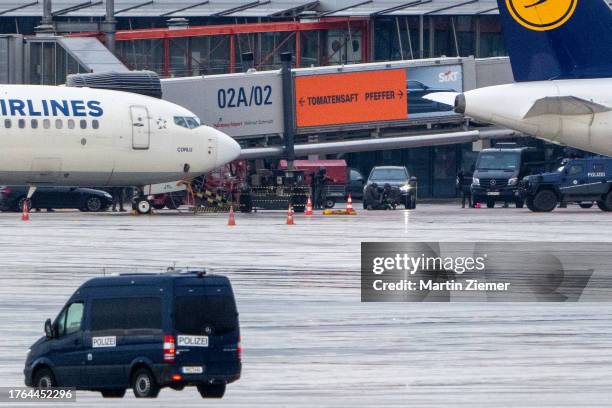 Police officers arrest the surrendering hostage taker on the tarmac at Hamburg Airport on November 5, 2023 in Hamburg, Germany. The hostage taker...