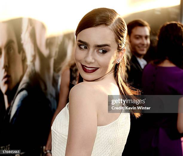 Actress Lily Collins arrives at the premiere of Screen Gems & Constantin Films' "The Mortal Instruments: City Of Bones" at the Cinerama Dome Theatre...