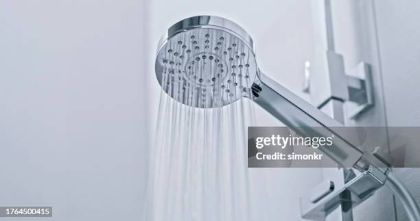 water flowing from shower head - shower head stock pictures, royalty-free photos & images