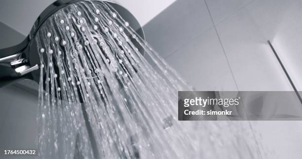 water flowing from shower head - shower head stock pictures, royalty-free photos & images